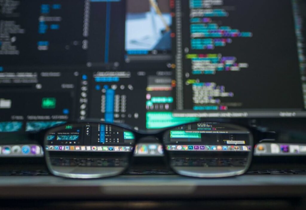 Glasses in front of computer screen, where the only clear part is through the glasses' lenses